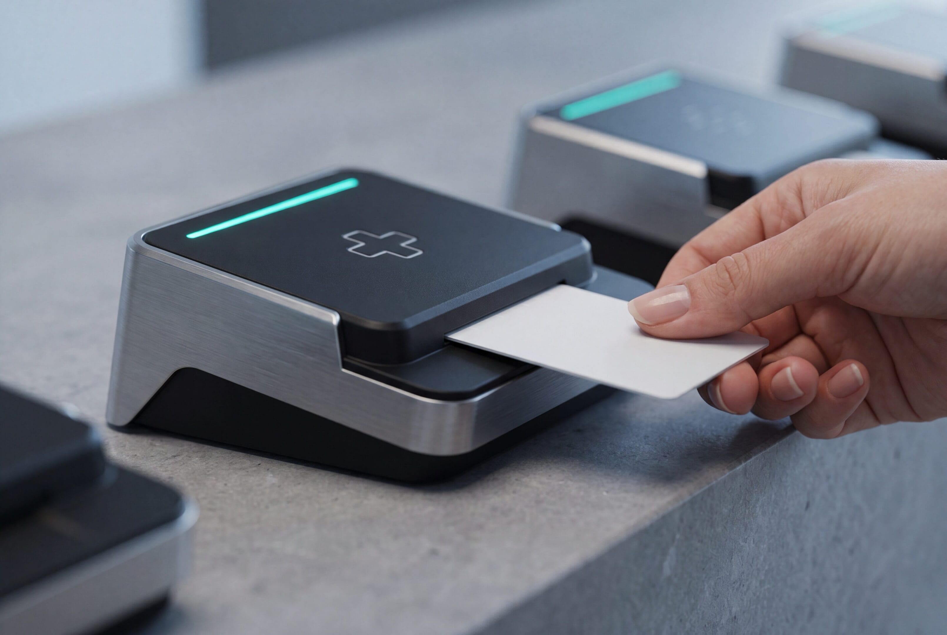 A patient using a smart card at a medical card reader terminal with a glowing green light, symbolizing EHR data interoperability, healthcare information technology, and the transfer of electronic health records.