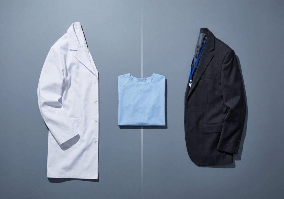Conceptual image for medical AI bias featuring a physician's white lab coat, a patient gown, and a corporate business suit jacket, illustrating how system prompts shift AI healthcare recommendations between doctors and insurance companies.